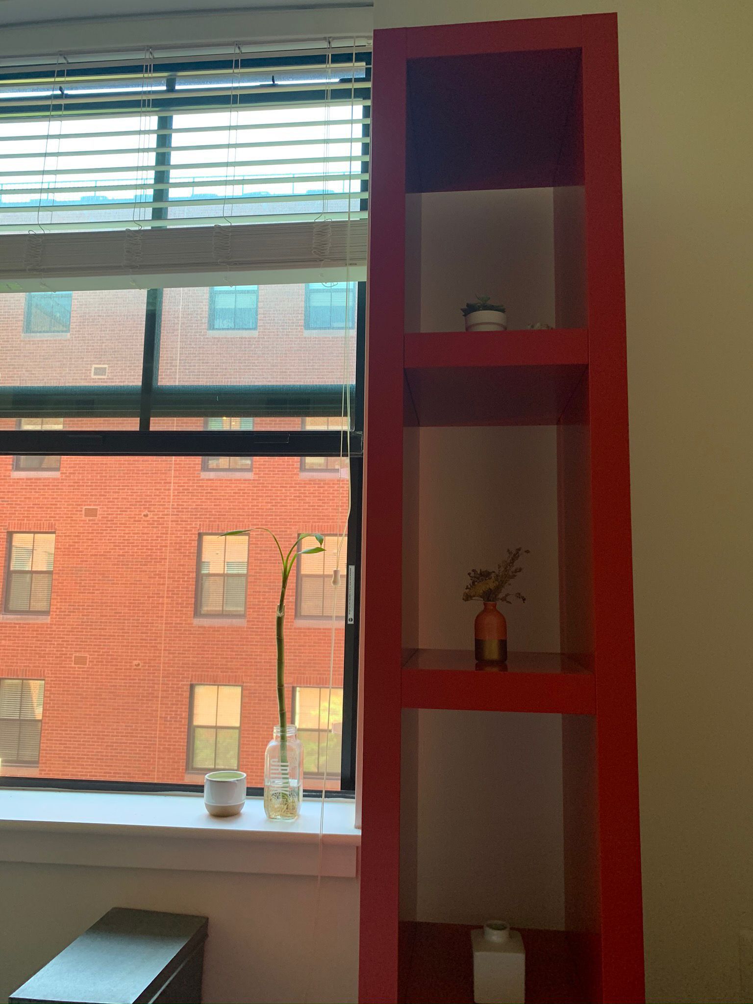 Two Ikea red bookshelves 