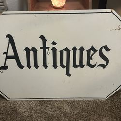 Antique Sign Hanging Out In Storefront
