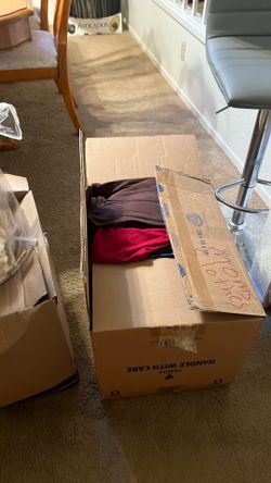 two boxes of women clothes and guys women medium size and guys small take everything free