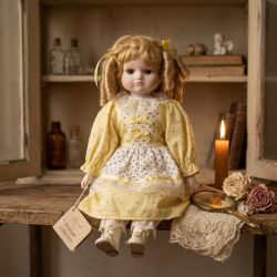 Porcelain Doll in a Yellow Dress