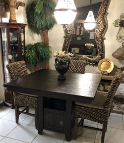 Dark brown high top with 4 wicker chairs without cushions