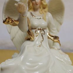 7" Porcelain Angel figurine HOLDING a White Dove. Sings "Evergreen"