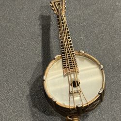 Vintage Banjo Brooch Damascene Style Gold Tone String Instrument Lapel Pin. Mother of Pearl banjo head. Made in Spain. Approximately 2” long.