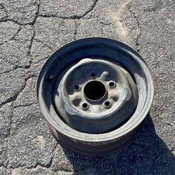 One 13-inch stock Chevy steelie 5 on 4.75 lug pattern