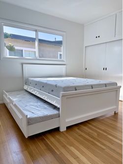 White full bed with mattress and trundle