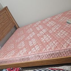 super comfy pink floral mattress with a wood bed frame