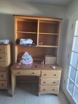 One desk, one dresser, and one end table. I believe it's walnut, really heavy and strong.