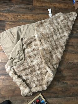 cozy, neutral-toned ruched faux fur throw blanket featuring a textured, plush exterior and a smooth microfiber backing
