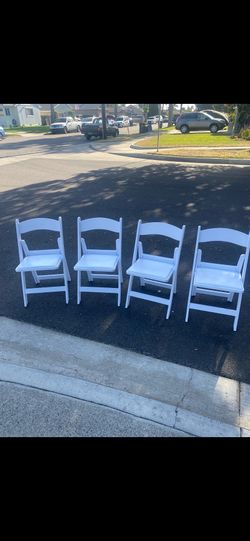 Brand new four luxury white folding  chairs for $60