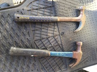 Construction claw hammers, solid, usable, one steel one fiberglass.