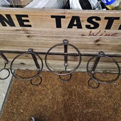 Rustic, wall-mounted wine rack made of wood and metal.