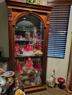 Curio cabinet would carved glass shelves doors open on the side.Perfect like queen new very heavy