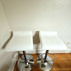 Pair Of White Faux Leather Adjustable Height Bar Stools With Chrome Base And Foot Rest