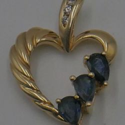 10KT YELLOW GOLD HEART PENDANT W 3 SMALL DIAMONDS; 3 SYNTHETIC SAPPHIRES 2.4 GRAMS. PRE OWNED. MINT CONDITION. 849283-3. 