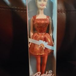 2005 Ballet Star Barbie doll, also known by the product number #J4029. The doll wears an orange/red sparkly ballet outfit with a white ribbon. 
Doll D