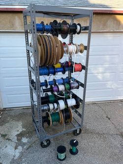 MULTIPLE REELS OF WIRE WITH TALL STEEL RACK