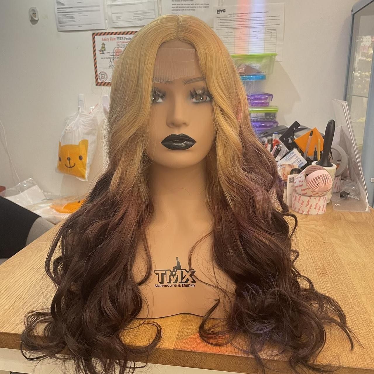 Human hair blend lace front blonde to brown wavy wig.