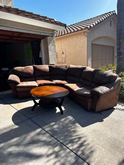 L-shaped brown couch and wooden coffee table