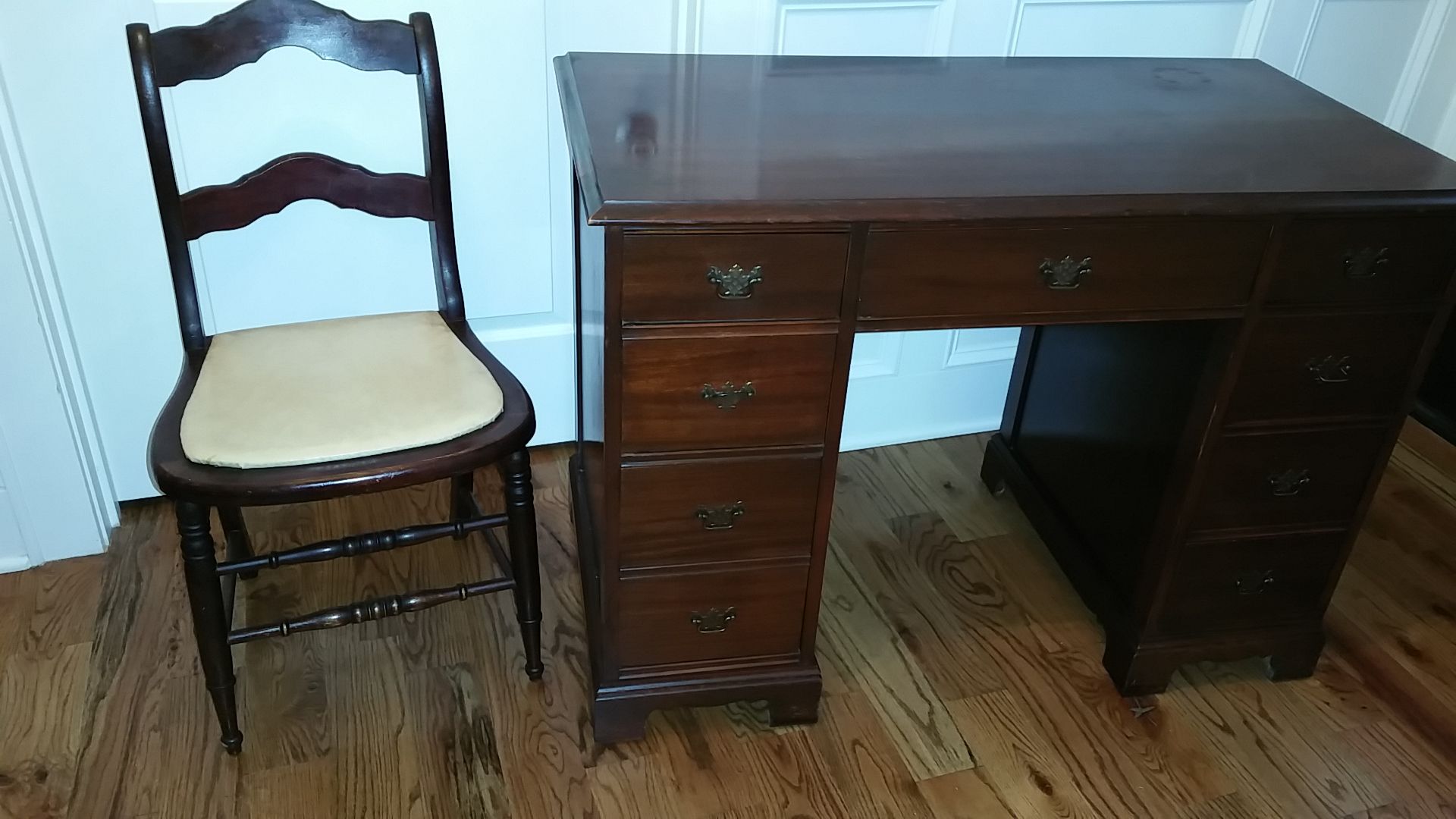 Antique desk and chair. Solid wood. Mahogany finish. 8 drawers. 1 deep. Chair has original seat. Family heirloom.