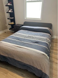 Full size bed with mattress, nightstand and floating shelves