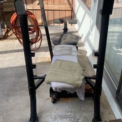 Weight Bench With 90 Pound Barbell with a leg lift