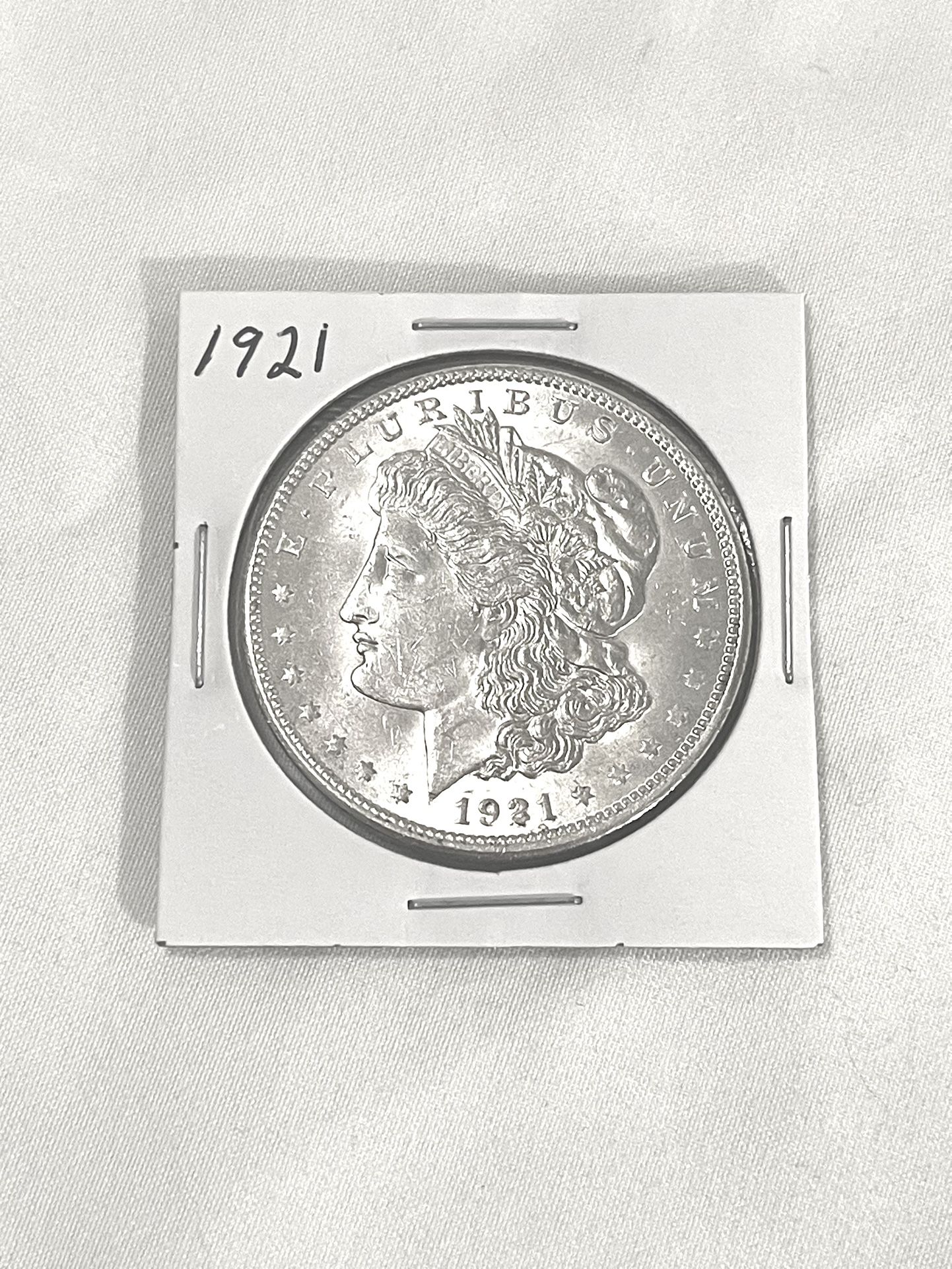 About Uncirculated-AU(50) 1921 Morgan Silver Dollar. This is valued at $72 on US Coin book.