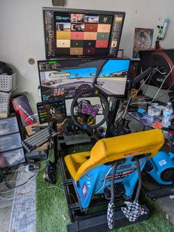 Racing Sim Cockpit Setup with Wheel and Monitors