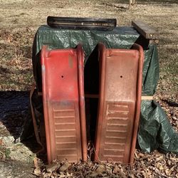 Two matching metal car ramps.