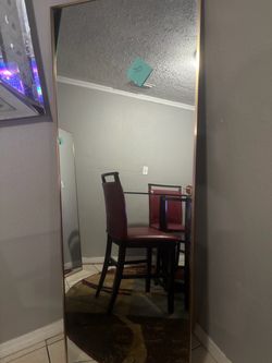 Two tall floor mirrors