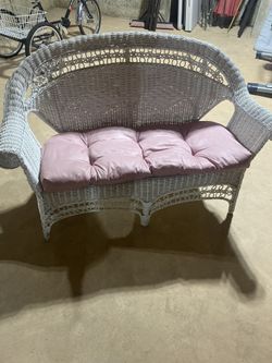 White wicker two seater w/cushion