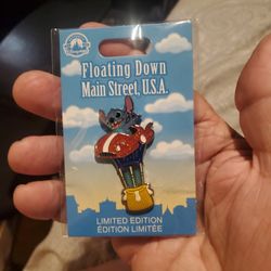 limited edition Disney Parks pin featuring Stitch from Lilo & Stitch floating in a hot air balloon as part of the "Floating Down Main Street, U.S.A."