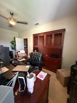 Executive desk: Large, substantial desk with paneled wood sides and a rich cherry/mahogany finish.