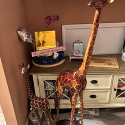 Mommy and baby giraffe carved in wood.