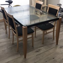 Glass table with four chairs