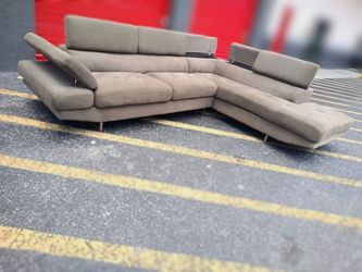 Free Delivery Today! Professionally cleaned L sectional. Modern couch. Headrest moves and has storage in couch! Wow