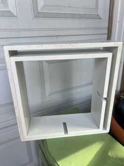 white wooden intersecting or cube floating wall shelves,
