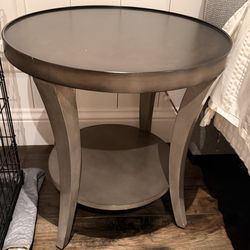 Two-toned round side table with bottom shelf