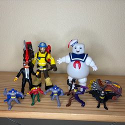 Set of action figures for boys. Includes ghostbusters marshmallow man, Fire Man, Fortnite, Skylanders, and Batman figurines.