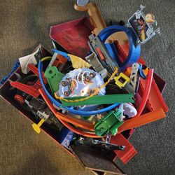 Box of assorted Hot Wheels track pieces and accessories