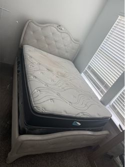 Bed frame with mattress and dresser