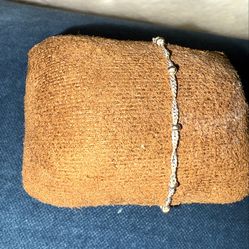 Macy's slim, minimalist-style bracelet in 925 sterling silver with a twisted chain or "rope" design. The bracelet is adorned with small metal beads or