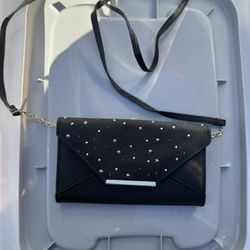  black clutch bag with a studded star pattern.