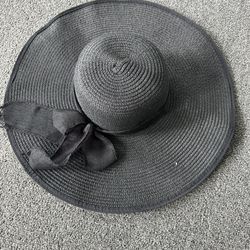 stylish black straw sun hat with a floppy wide brim