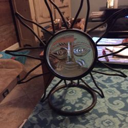Sun with candle illuminating holder