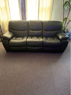 Black Faux Leather Reclining Sectional with Center Console, USB Ports, Storage, and Lighting.