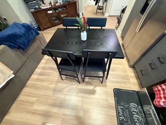Black wooden table seats 4￼