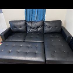 Black Leather Couch With Tear On Ottoman 