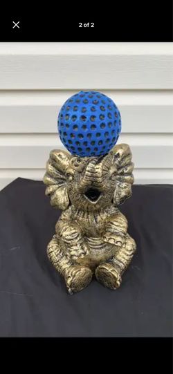 Elephant balancing ball statue