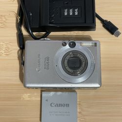 Canon Powershot IXUS 60/Elph SD 600 digital camera - tested works  Flash zoom video photo all working. Battery, 2GB memory card and charger included. 