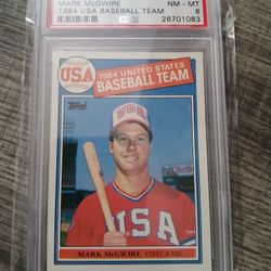 1985 Topps Mark McGwire Rookie Card, specifically card #401, featuring him as part of the 1984 USA Baseball Team and graded PSA 8 (NM-MT). 